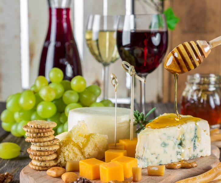 Cheeseboard with two glasses of wine